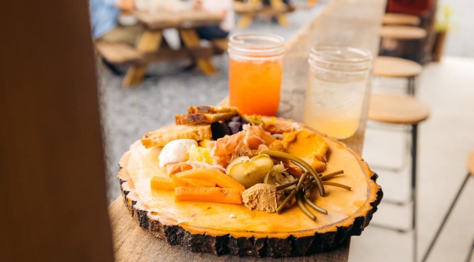 A wood plate of fresh produce.