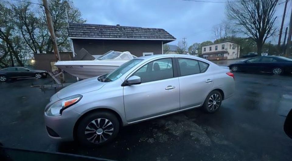 A silver 2019 Nissan Versa available for taxi rides