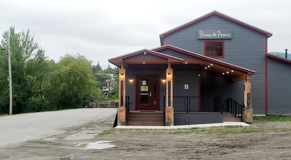 A blue building with a large covered entryway.