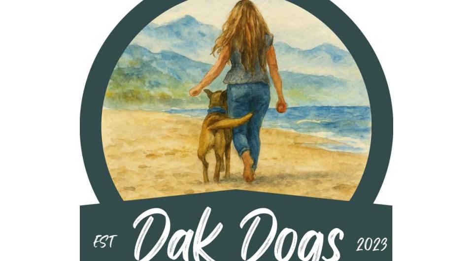 A logo ring with Dak Dogs est 2023 with a blonde woman and a dog walking the beach