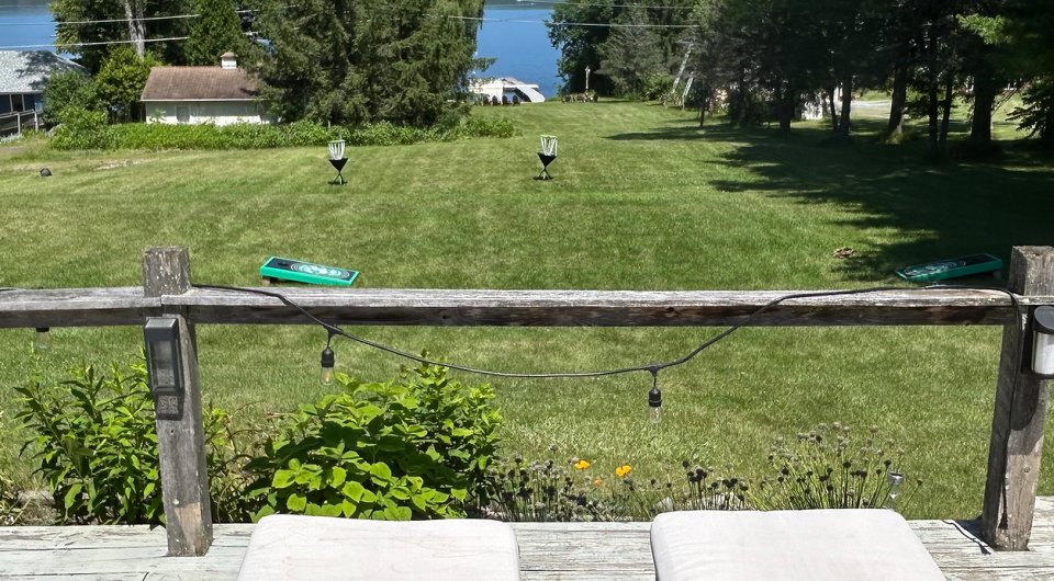 A sprawling lawn overlooking the water of Lake Champlain.