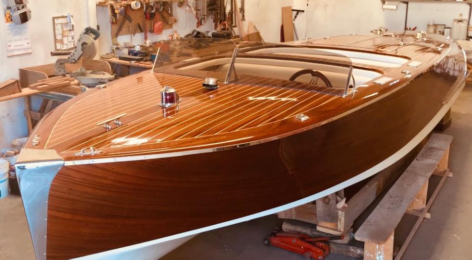 Finishing touches are put on the restoration of a beautiful wooden boat