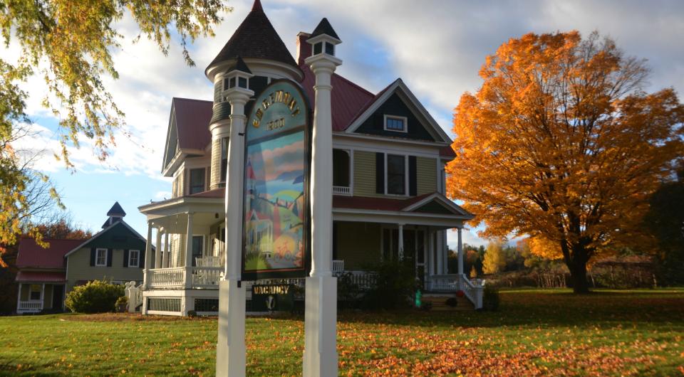 The front entry sign with the historic home in the background.