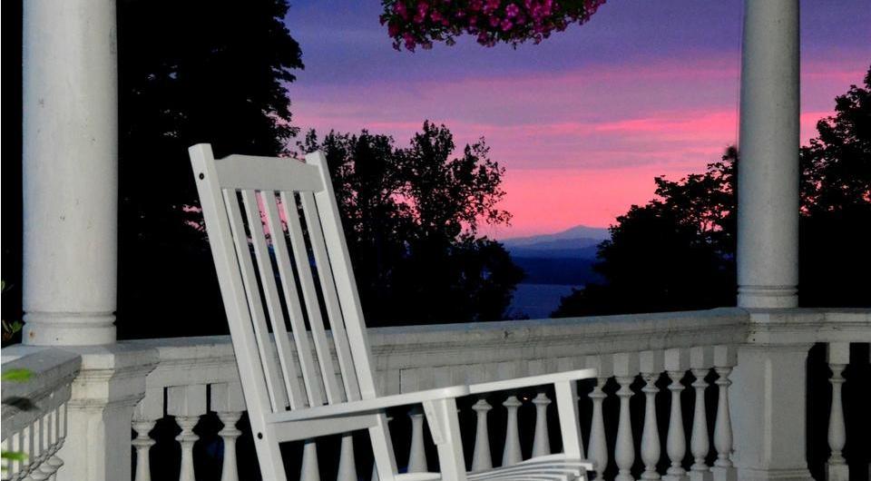 Pink & purple sun set from the white rocking chair on the covered porch.