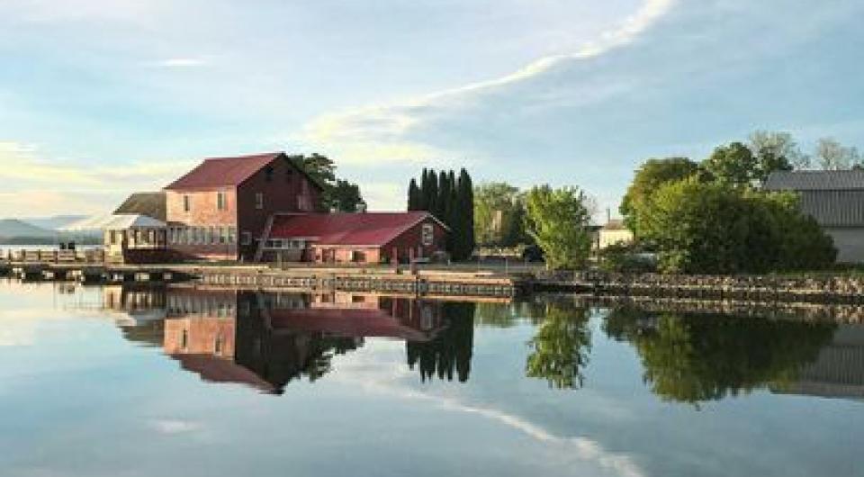Looking from the Ferry loading dock towards the Old Dock Restaurant on a perfectly still day where the water reflects the sky