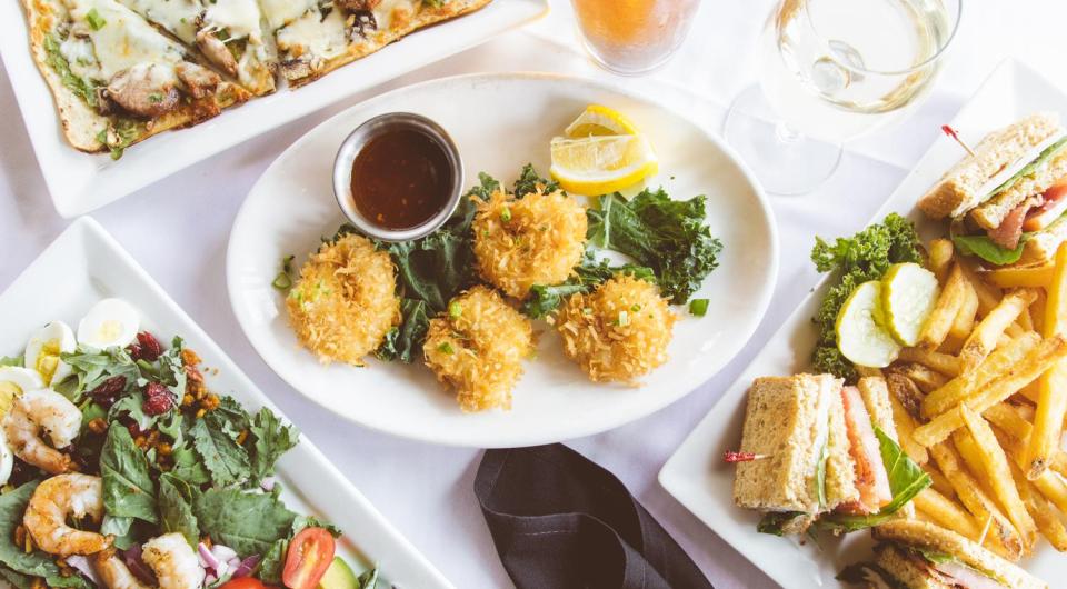 A variety of delicious meals on white plates at The Old Dock Restaurant.