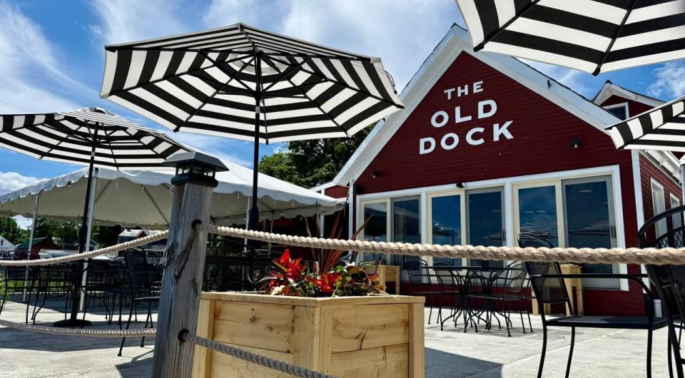 Black and white sun umbrellas on the roped off deck of The Old Dock Restaurant.