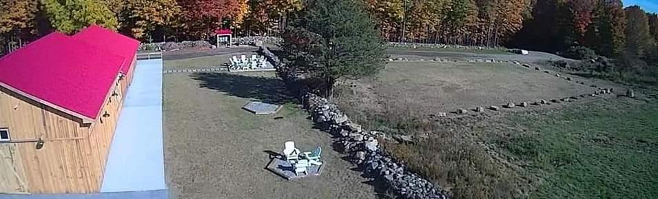 An aerial view of the wedding barn and outdoor space with firepit.