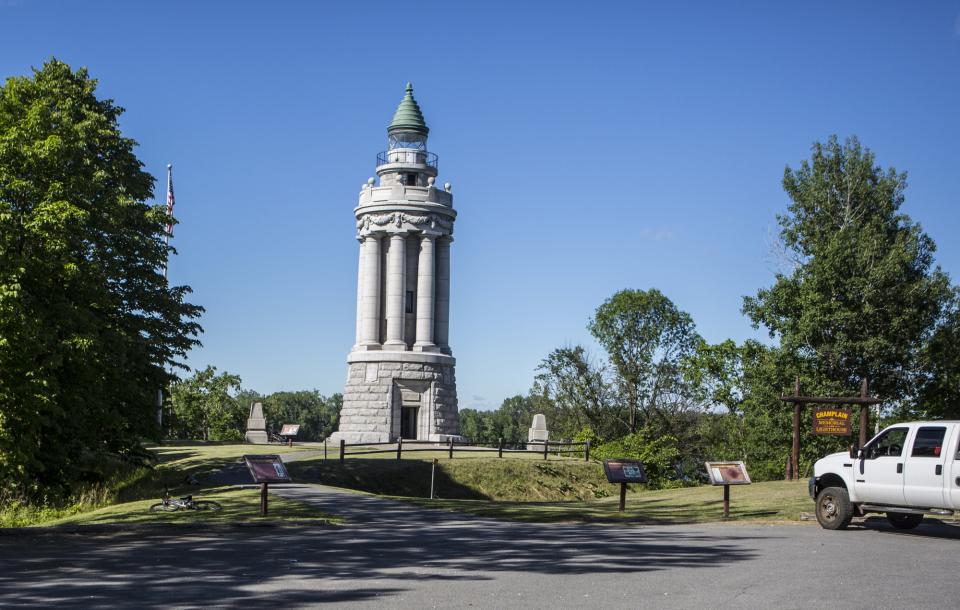 A tall historic stone monument against a blue sky