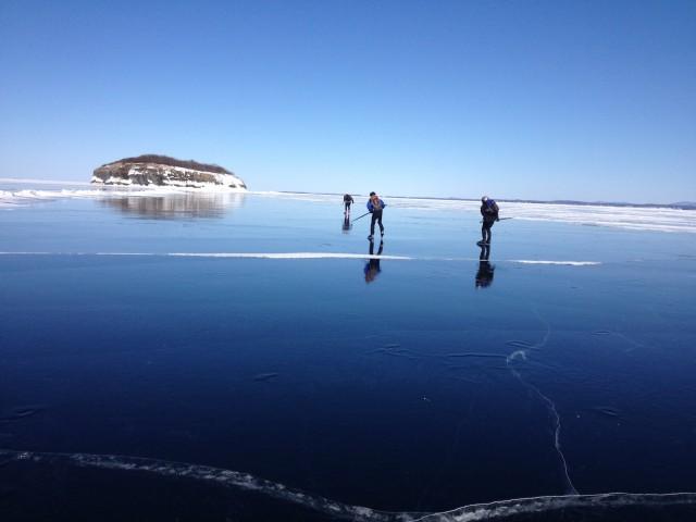 Skaters approaching the Four Brothers islands on Lake Champlain.