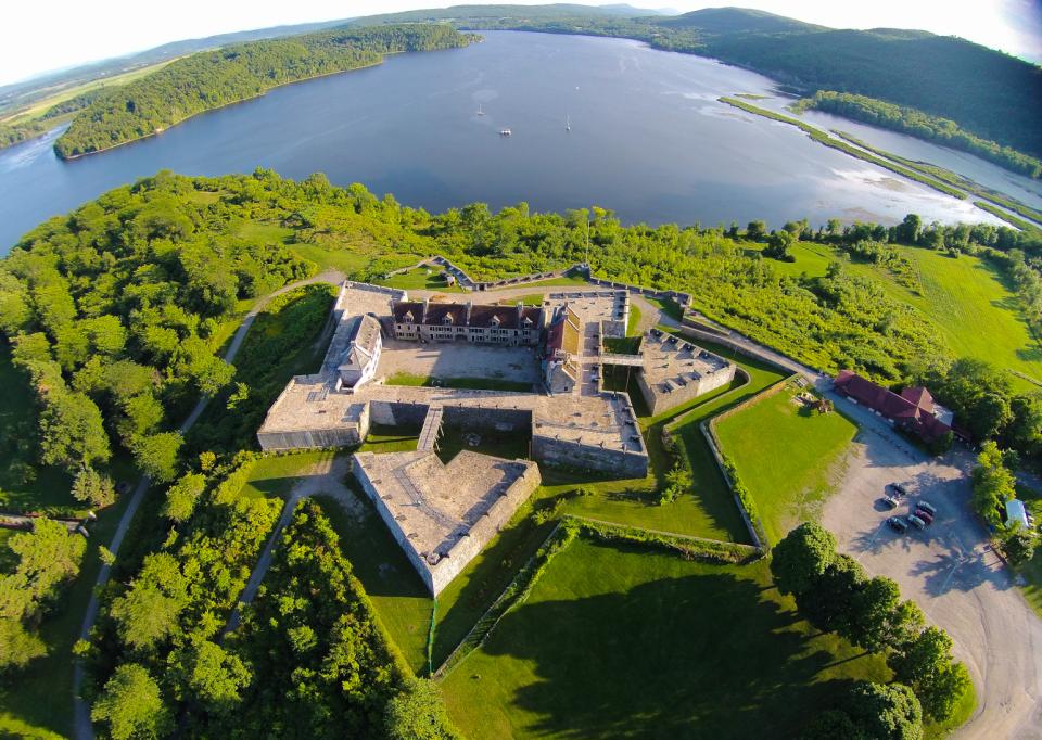 Aerial view of star-shaped Fort Ticonderoga with Lake Champlain beyond.