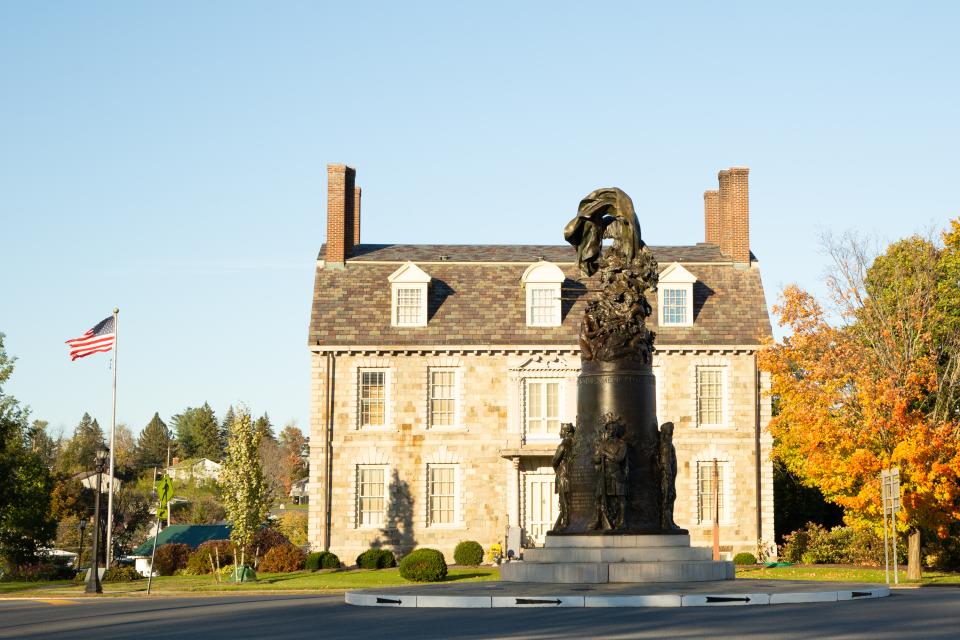 The elegant stone Hancock House and bronze Liberty Monument.