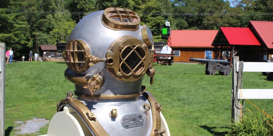 An antique metal diving suit on the lawn of the Maritime Museum.