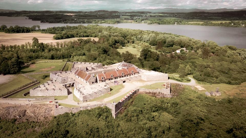 An aerial view of Fort Ticonderoga and the surrounding lake and rolling hills.