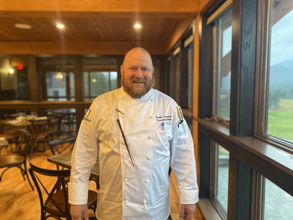 A portrait of the chef standing in his dining room