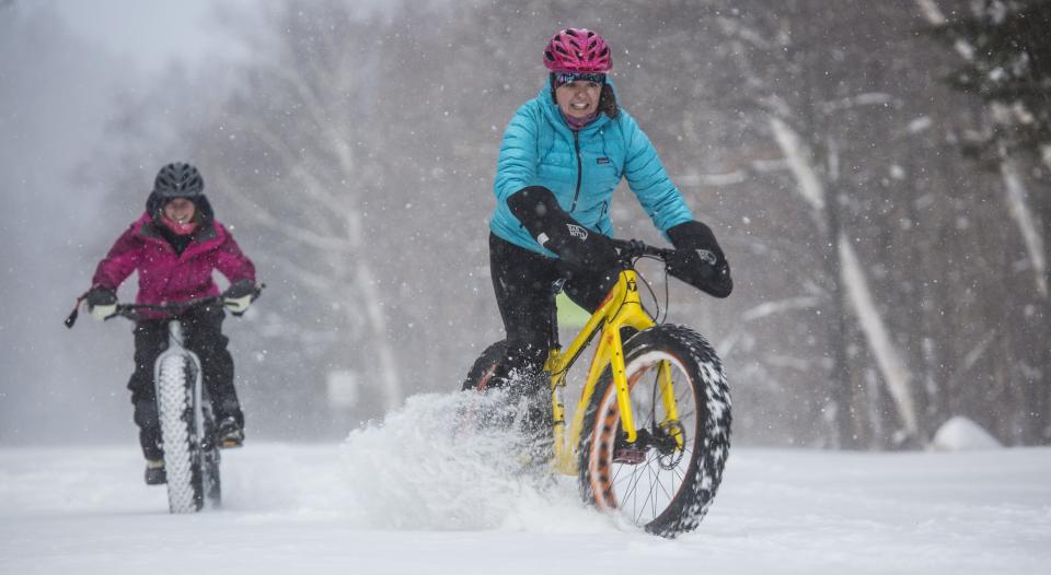 One rider starts to slide as she and her friend ride fat tire bikes through the snow.