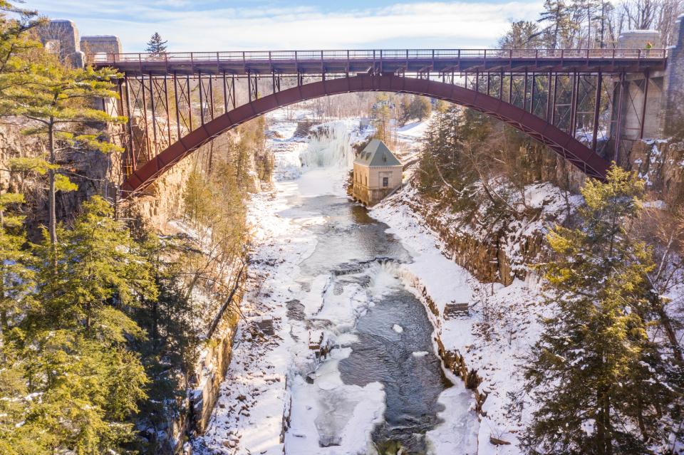 A bridge crosses over a frozen river.
