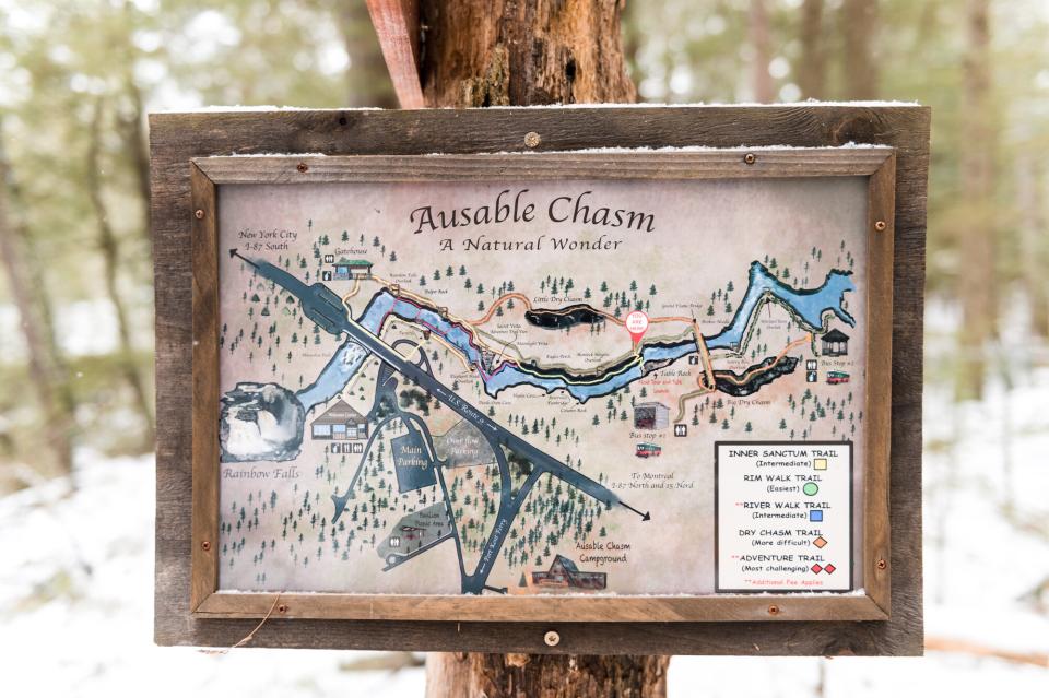 A framed map of the Ausable Chasm trails is nailed to a tree for hikers and snowshoers to orient themselves with.