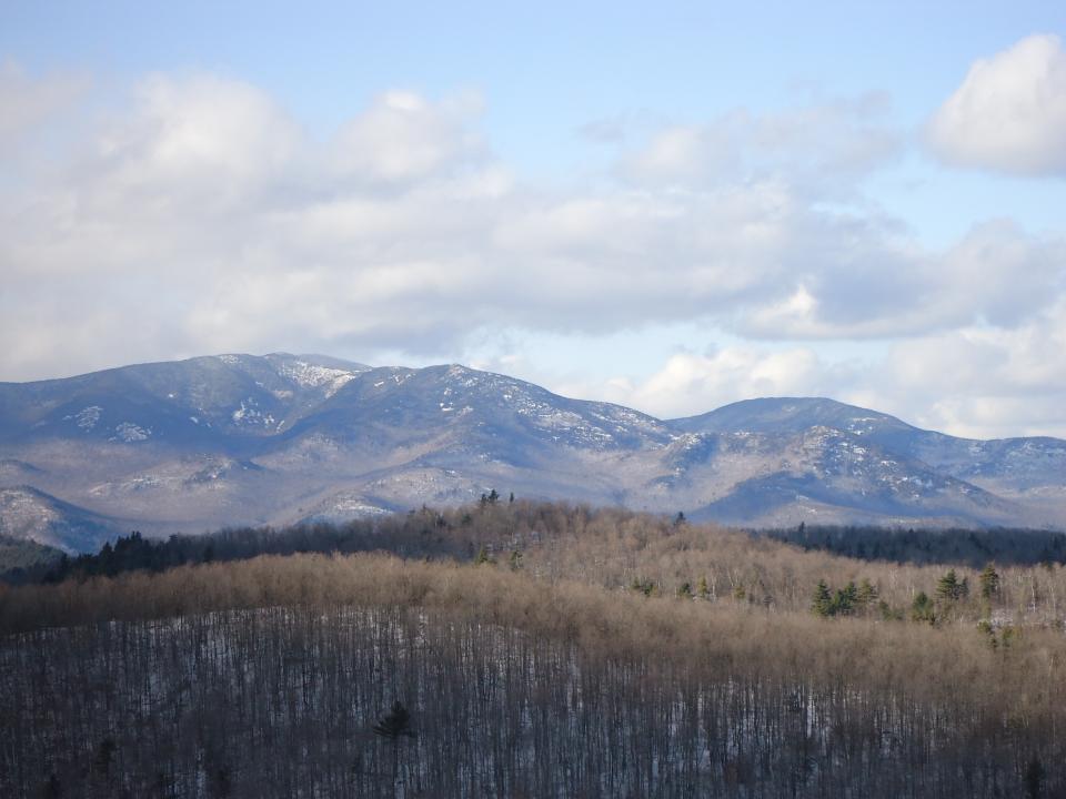 A winter view from Belfry, with snowy High Peaks in the distance.