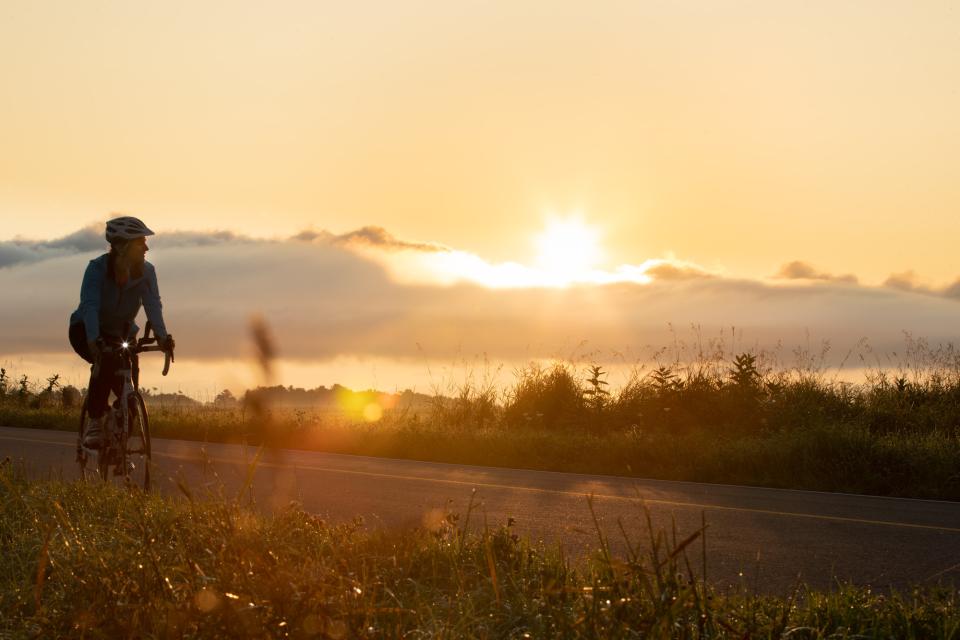 Erin Hanczyk rides among the fields of the Champlain Valley as the sun crests over the horizon.