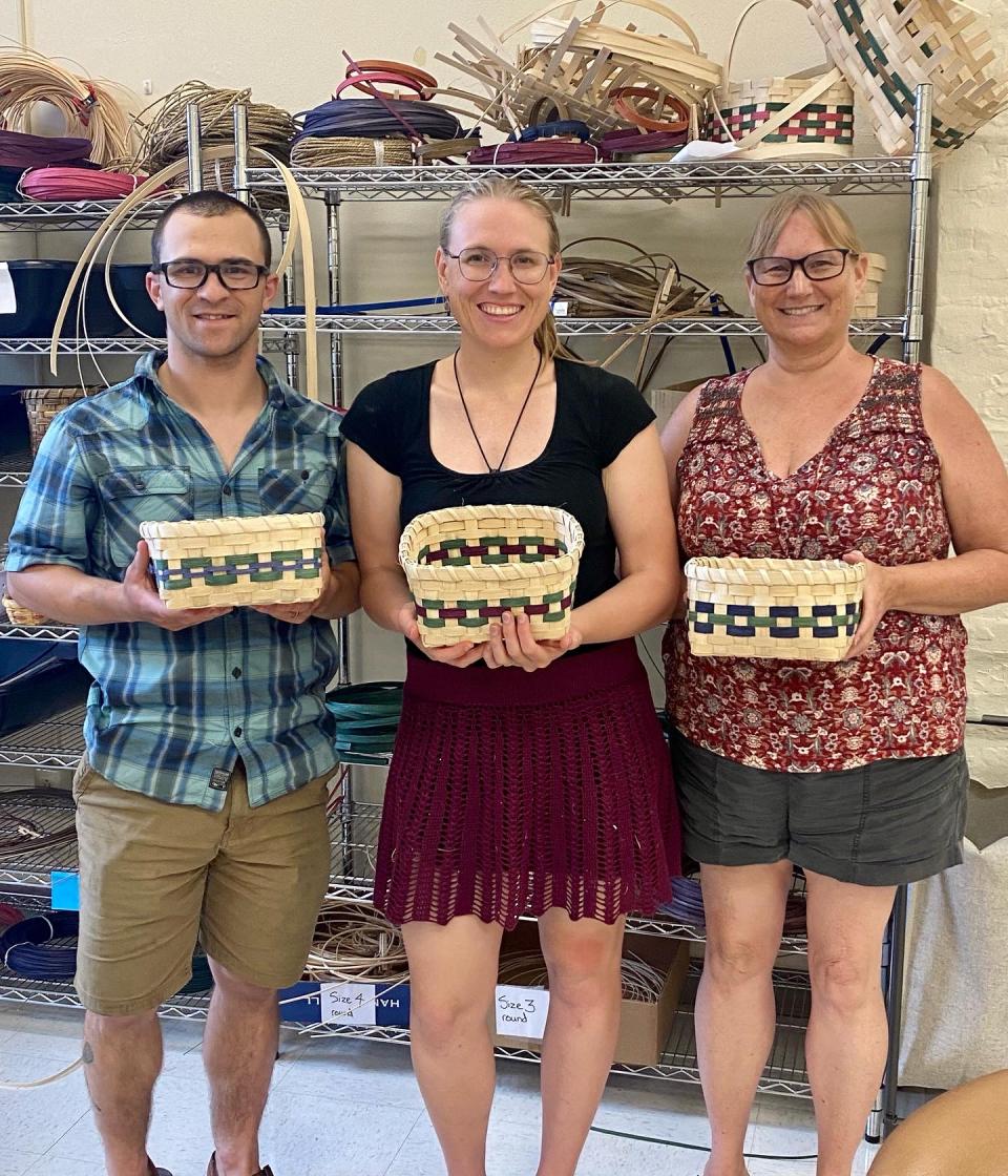 3 friends pose with their finished baskets