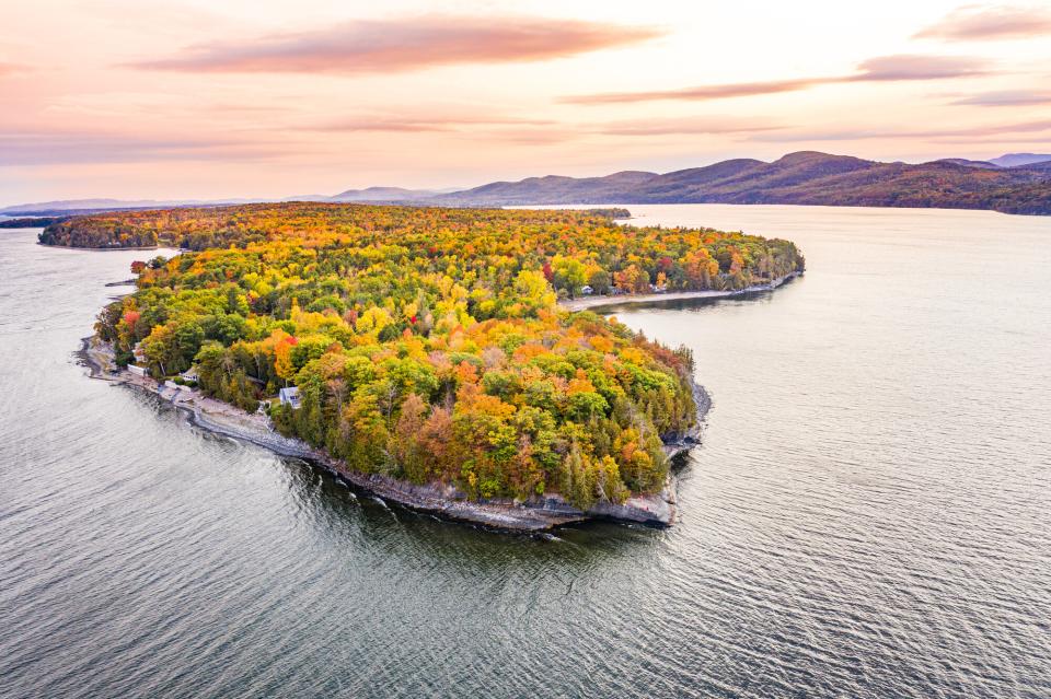 An aerial view of fall colors on an island peninsula on Lake Champlain.