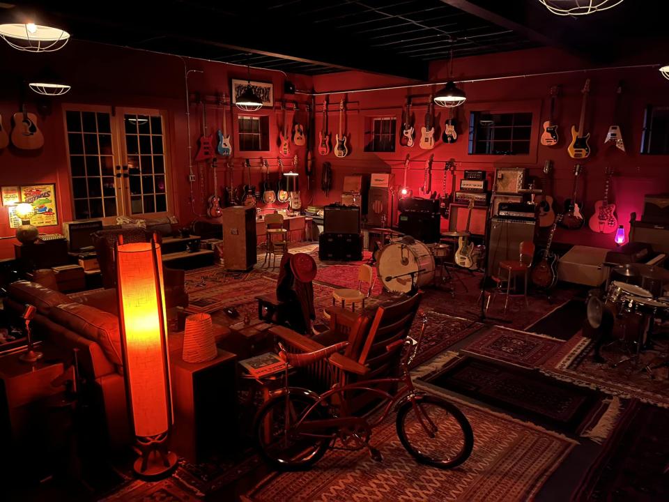 Vintage instruments, guitars, and other curiosities displayed in a room at Champlain Peony Company