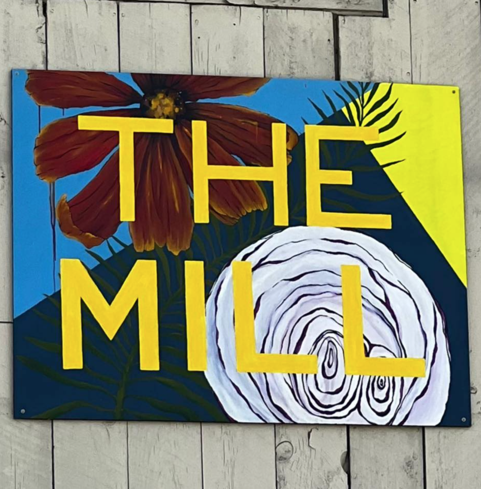 A brightly colored, hand-painted sign for the Mill in Westport