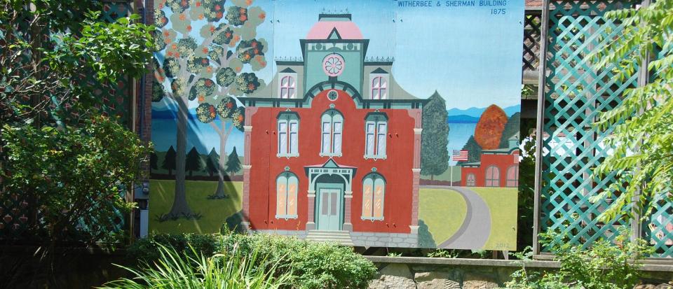 A colorful mural depicting a victorian building.