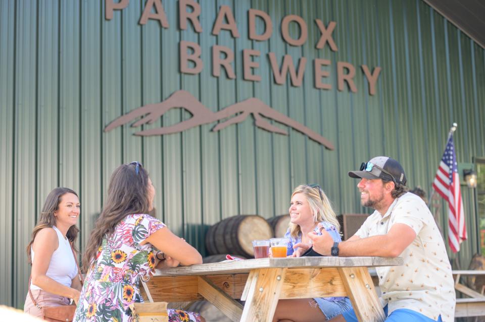Four friends enjoying beers at Paradox Brewery