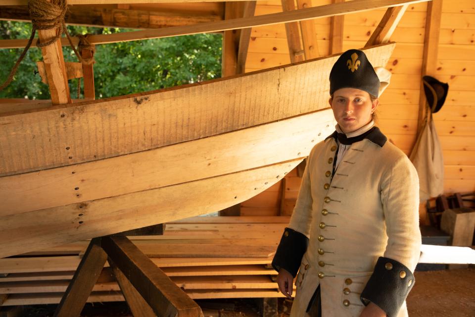 A man wearing period clothing participates in a reenactment at Fort Ticonderoga