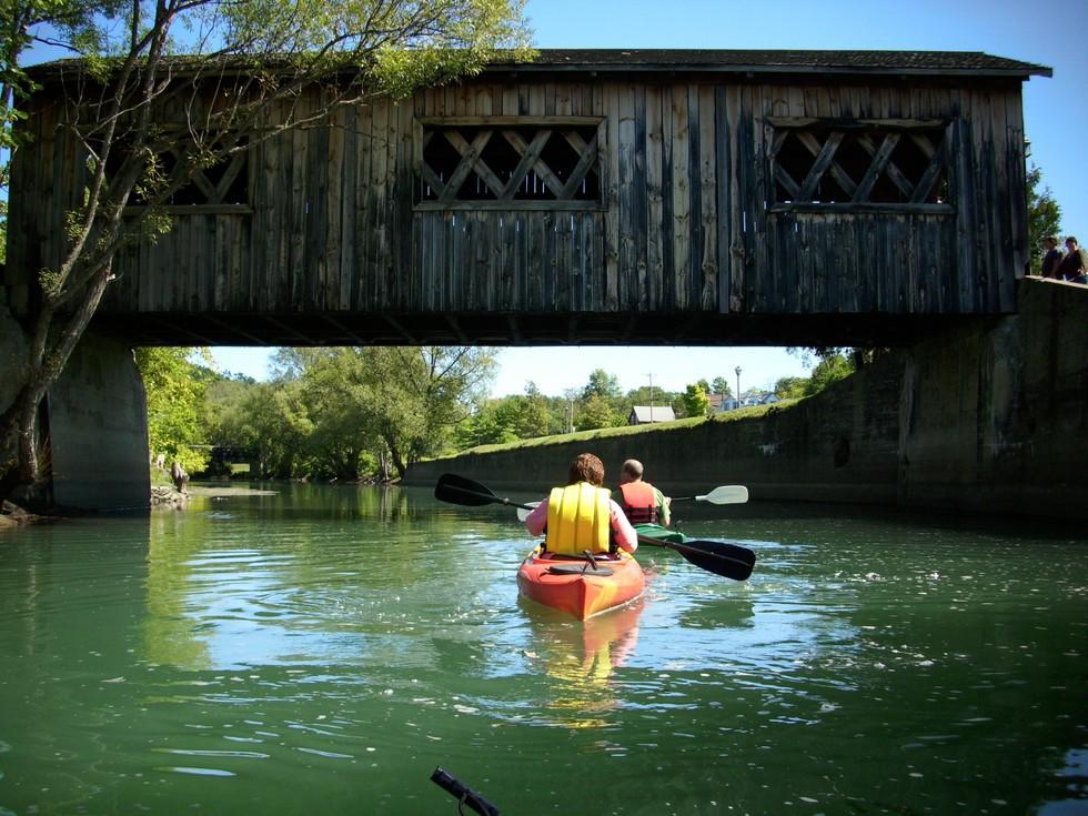 Paddle under historic bridges on the La Chute River.