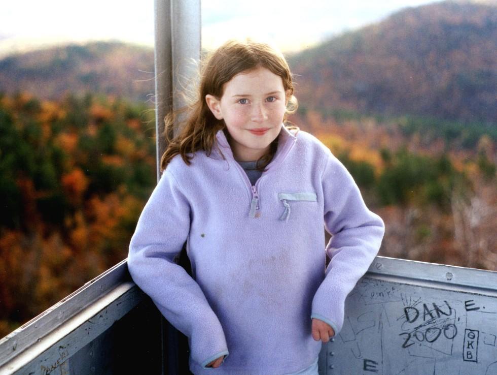 Girl standing in a firetower during Autumn