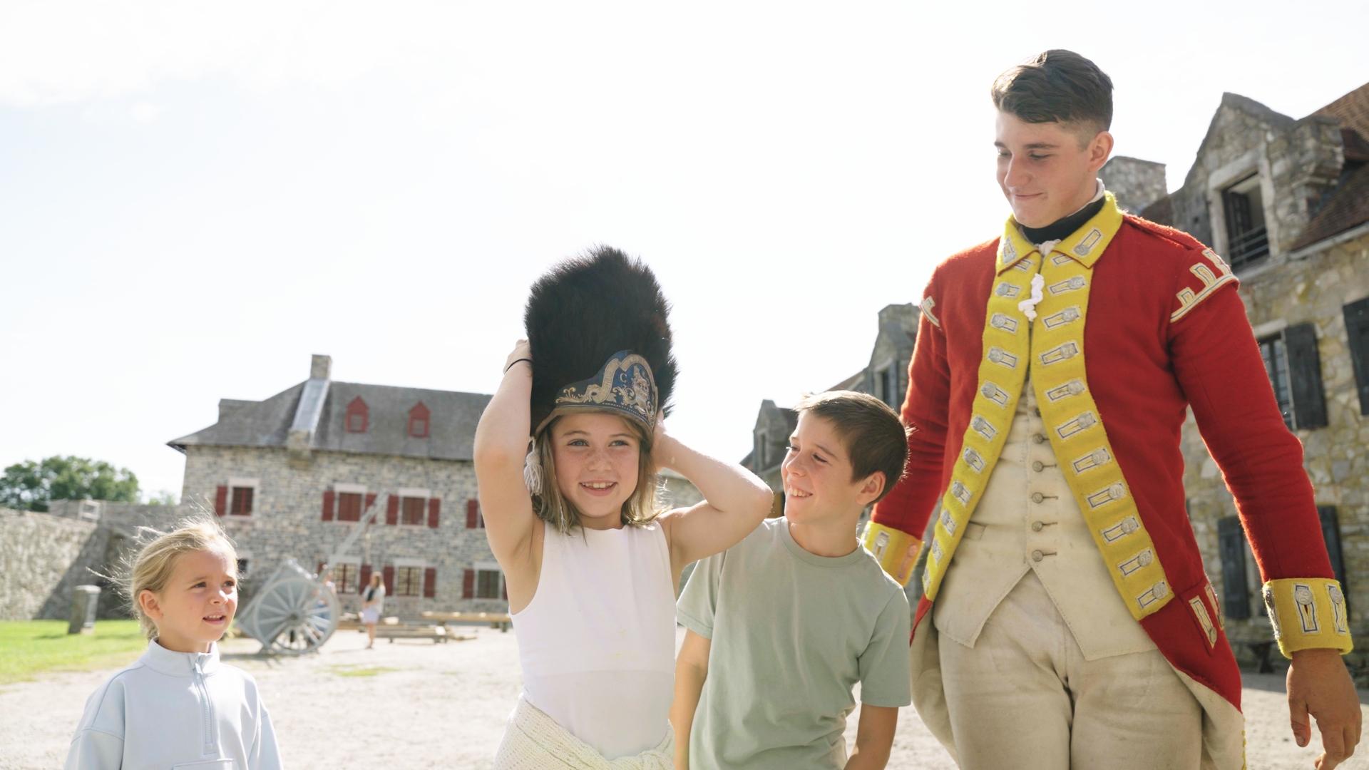 Kid in period garb smiles at camera