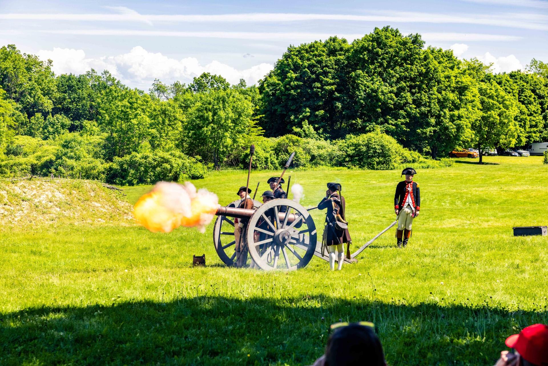 A cannon firing from the wall of the battlements