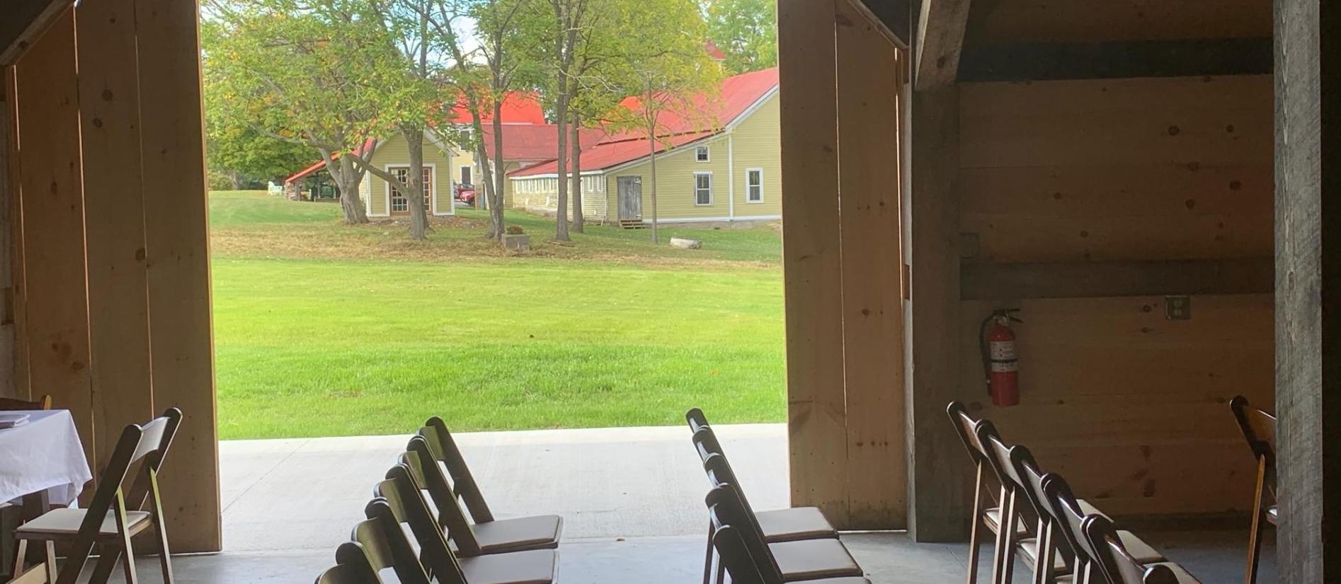 The doors of the barn rolled open to show the large grassy yard.