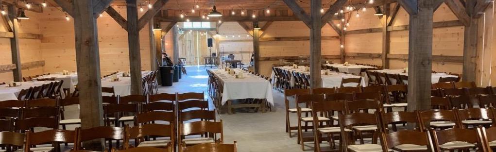 Backed up view of the tables set with white linens