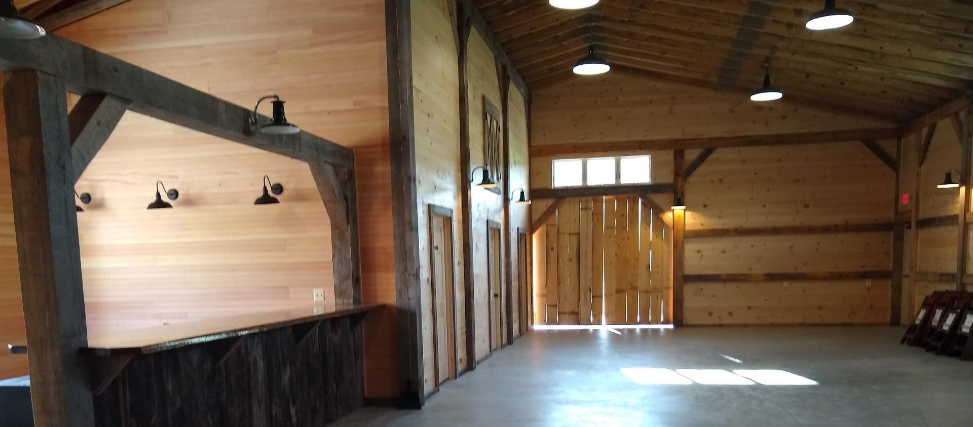 Tall ceiling of the barn by some storage rooms.