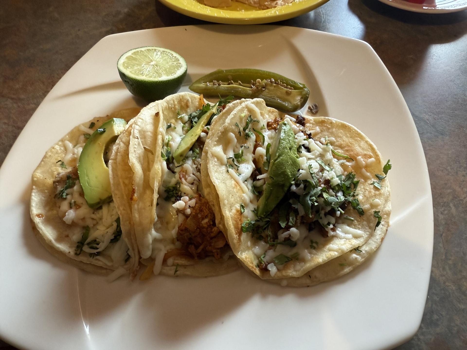 A plate of tacos with assorted meat choices.