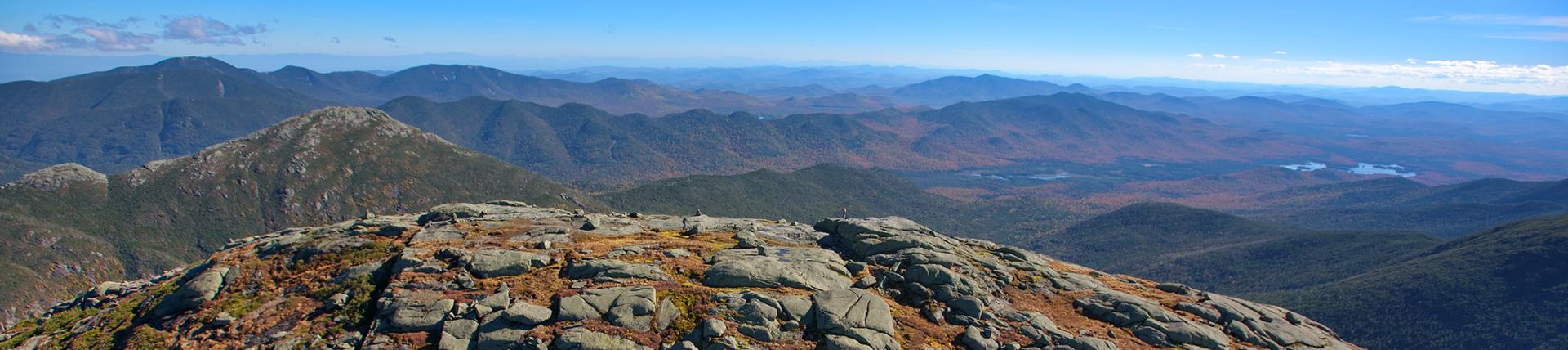 The rocky peak of a mountain looking out over the horizon.