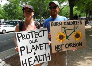 People holding signs petitioning for protection of our planet.