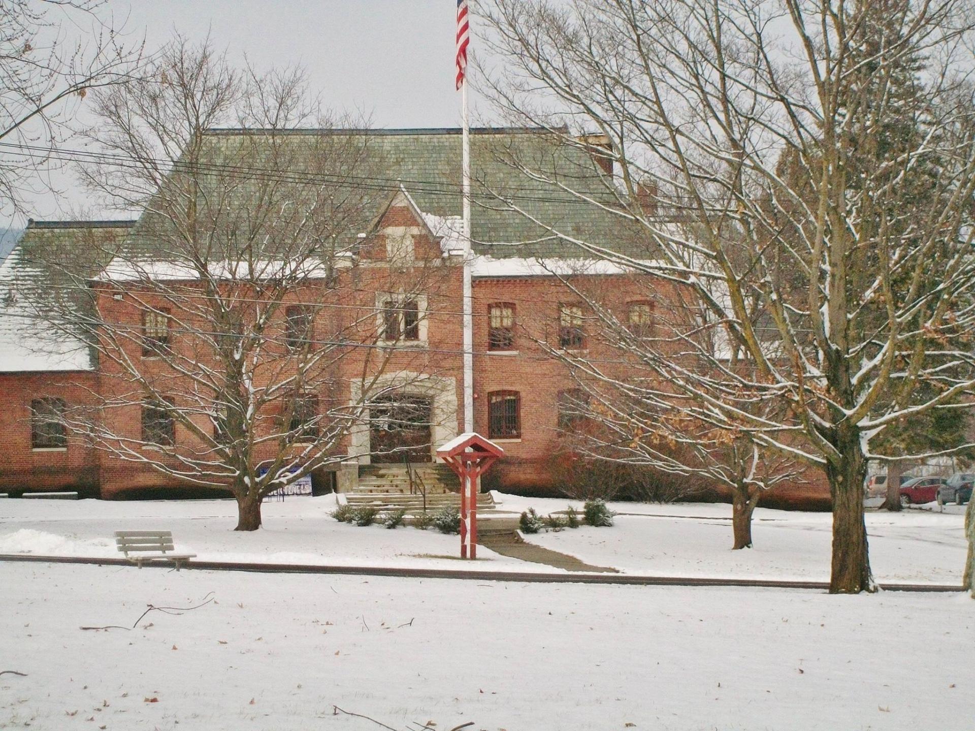 A large brick structure blanketed in fresh snow.