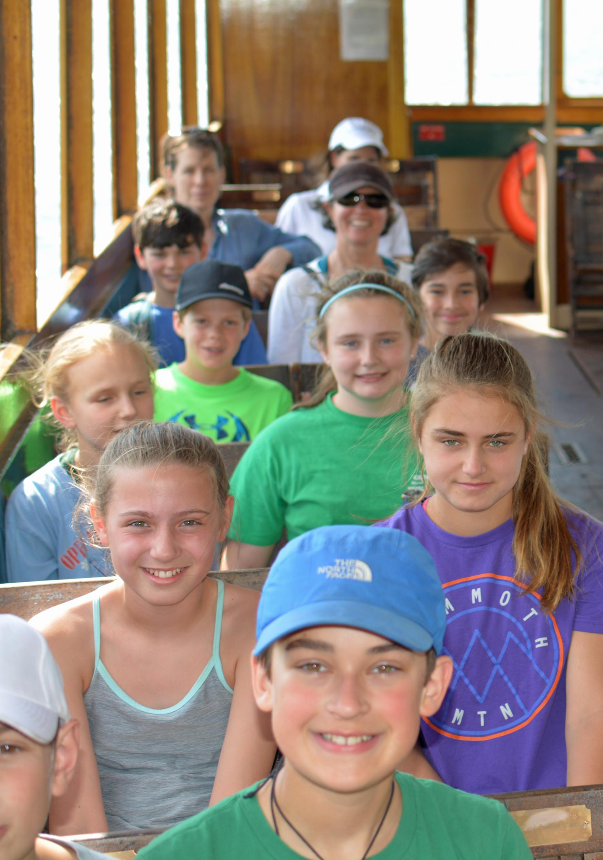 Students smile from their seats on the Carillon Boat Cruise