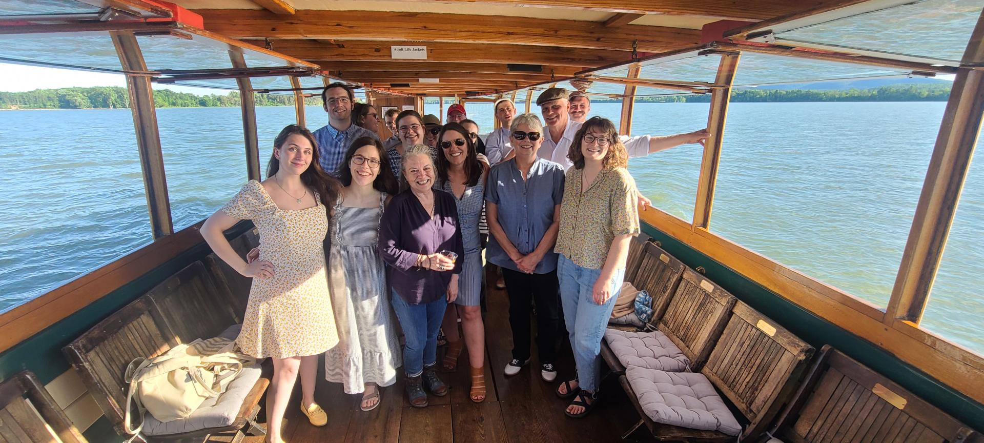 A group of people stand together smiling into the camera on the