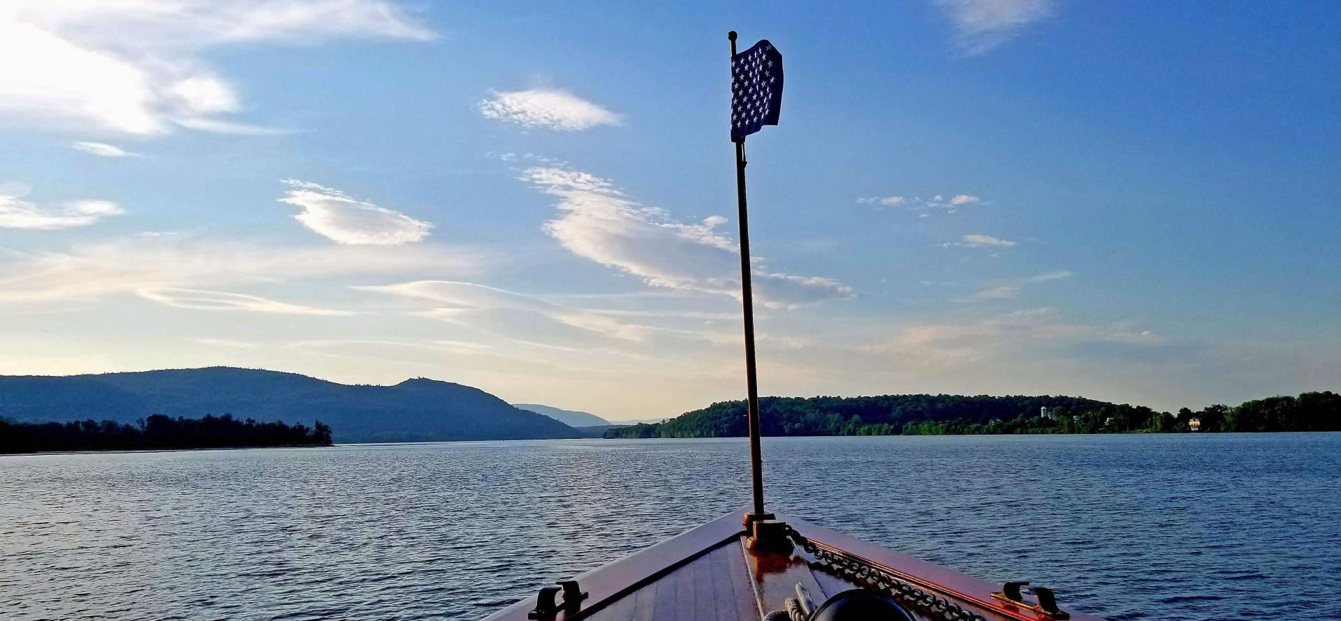 A view from the bow of the Carillon looking out over the waters of Lake Champlain and the surrounding mountains.