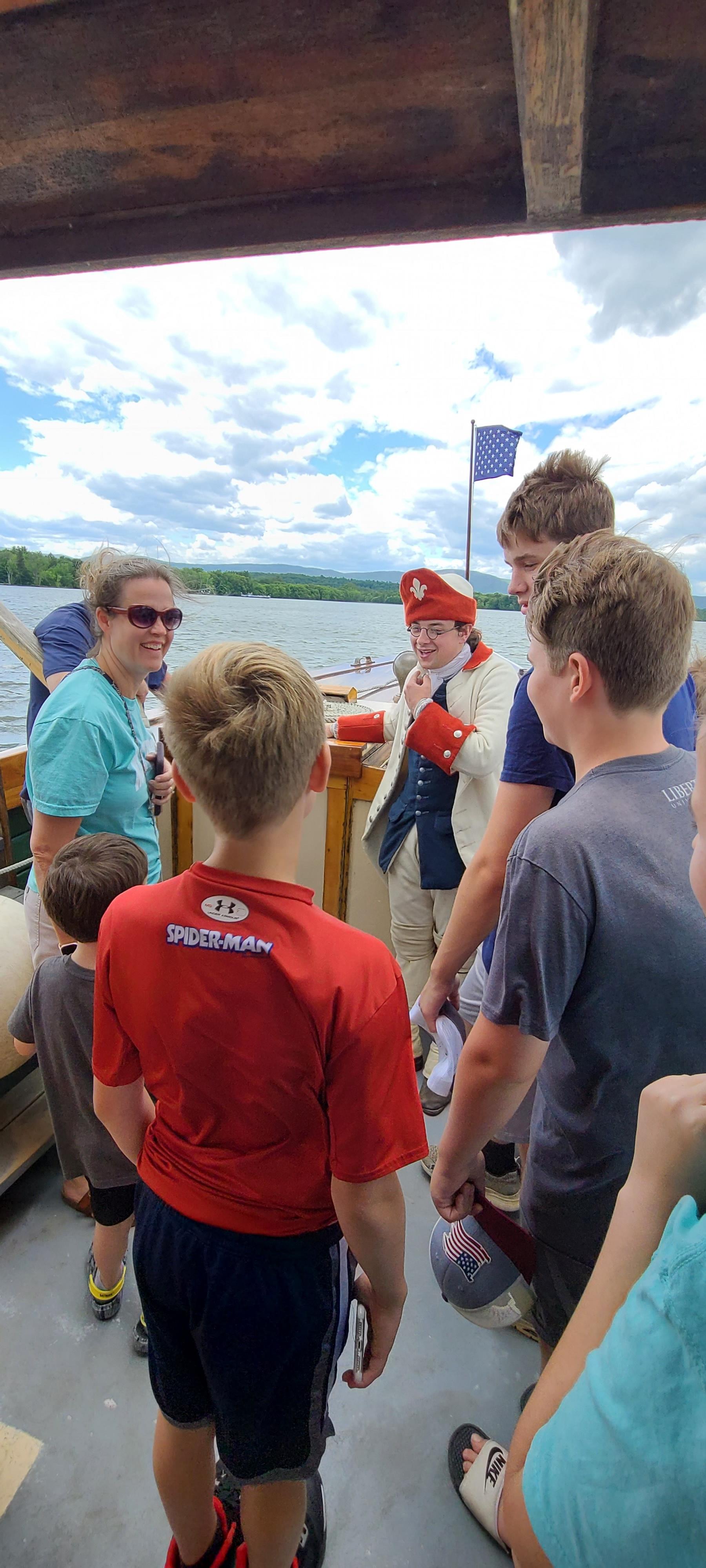 The captain of the Carillon speaks to the public aboard the boat cruise.