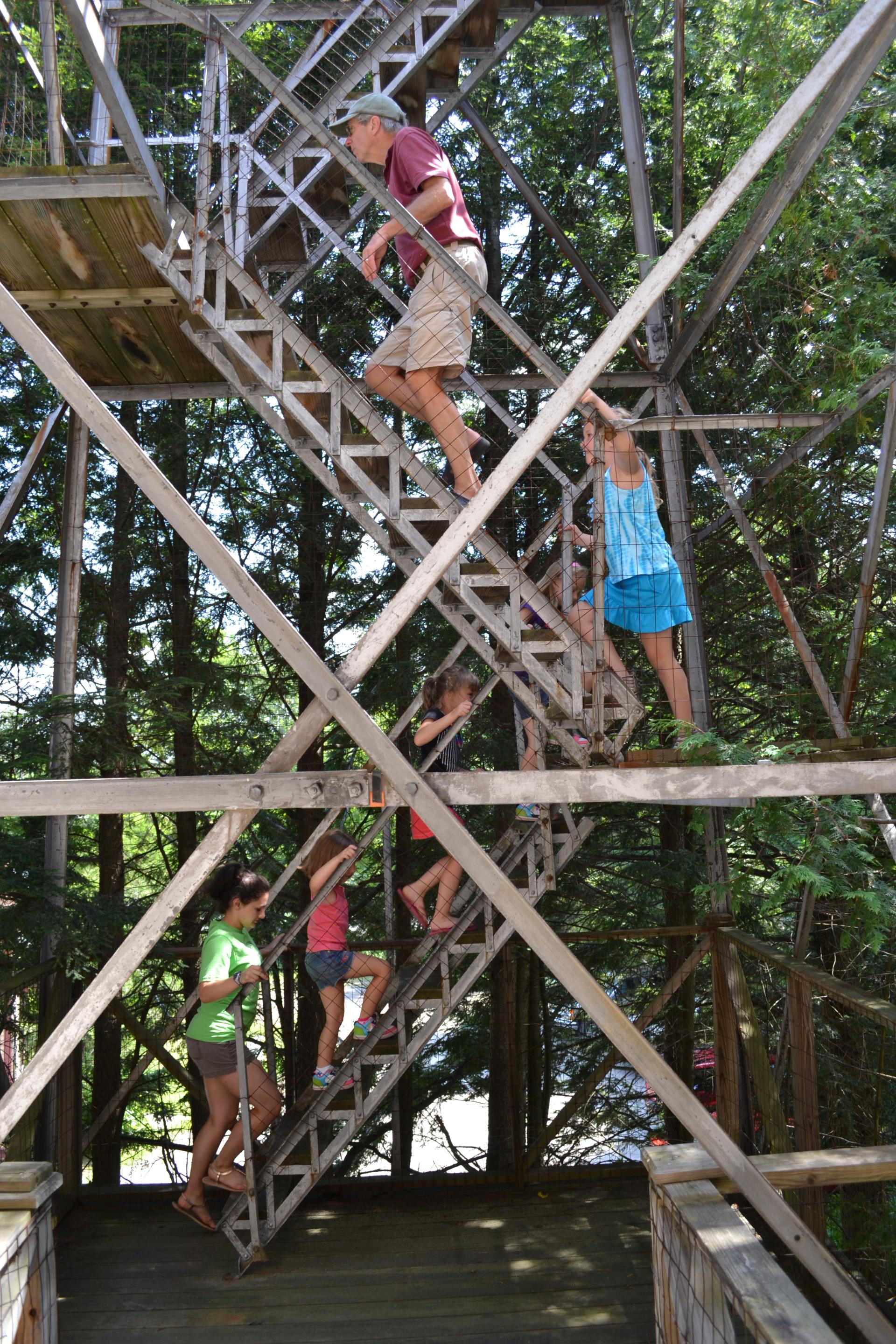 People climbing a fire tower steps.