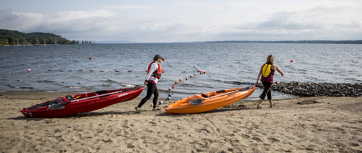 kayakers carting kayaks to water