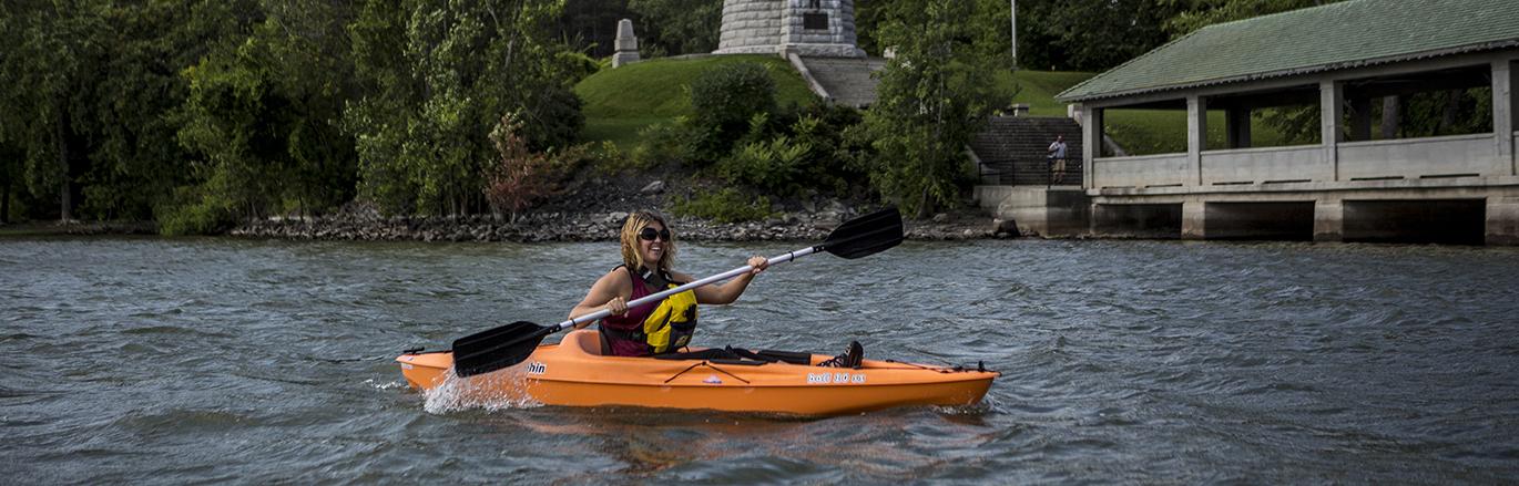 kayaker paddling near lighthouse