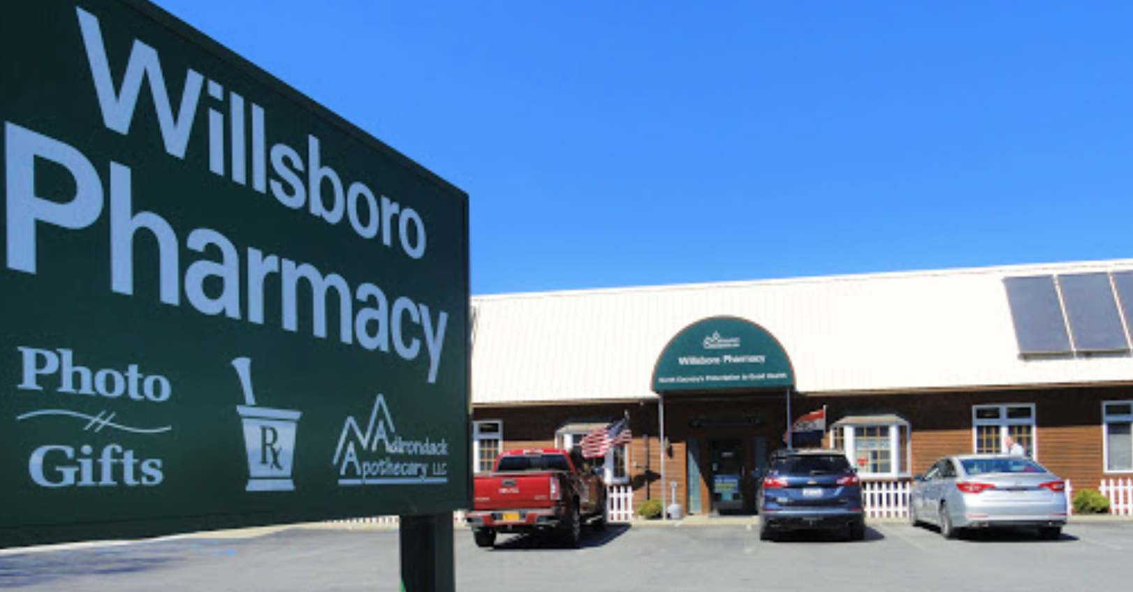 The front of Willsboro Pharmacy and entry sign.